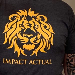 Black t-shirt featuring a stylized gold lion face design centered on the chest, with the text “Impact Actual” printed underneath.